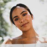 Close-up portrait of a smiling woman with beautiful eyes in natural light.